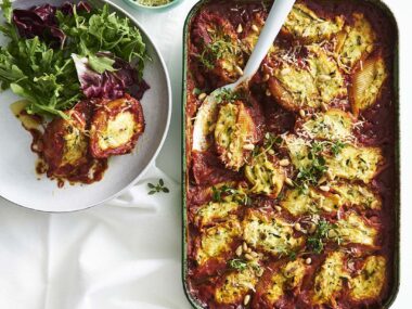 Baking dish filled with stuffed pasta shells and a tomato sauce