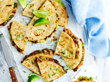 Quesadilla with black bean and corn with lime wedges