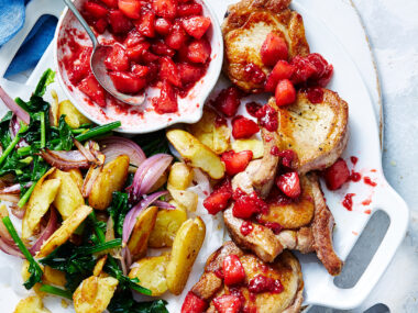 Pork cutlets with apple berry sauce with potatoes, spinach and onion
