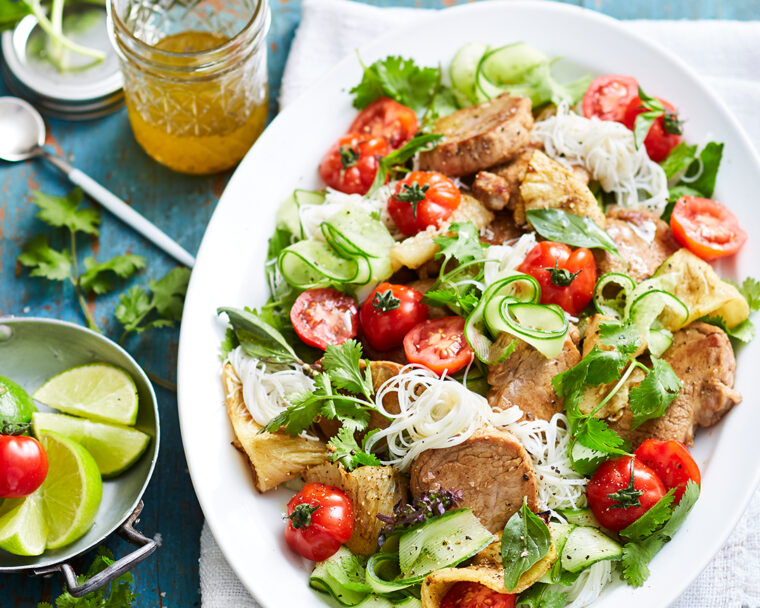 Sweet and sour pork with rice noodle salad on a serving platter